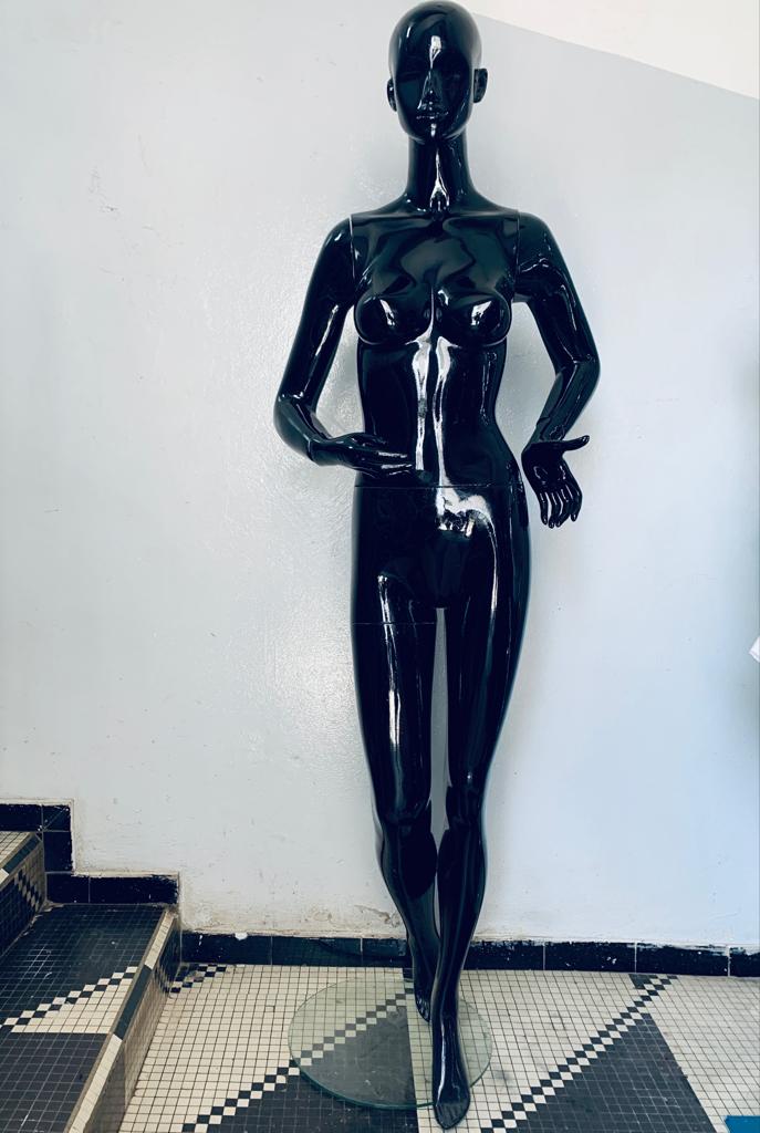 a statue of a man standing on top of a tennis court 