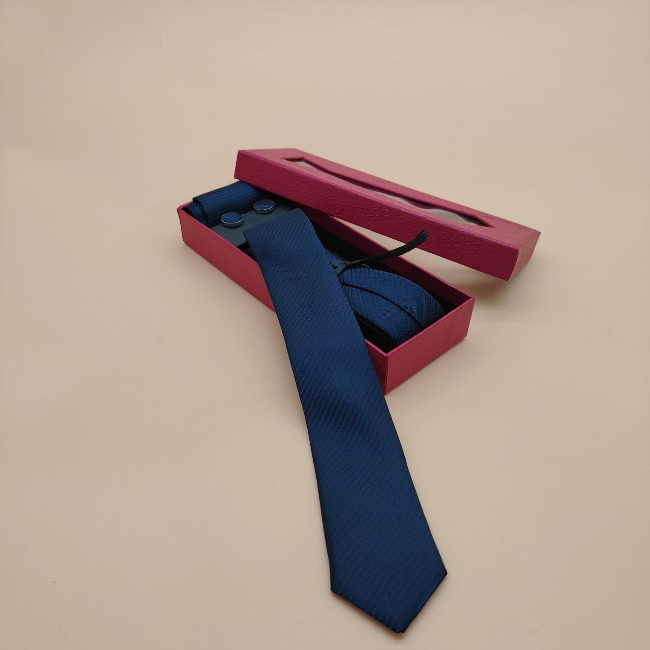 a person in a blue shirt and a red tie 