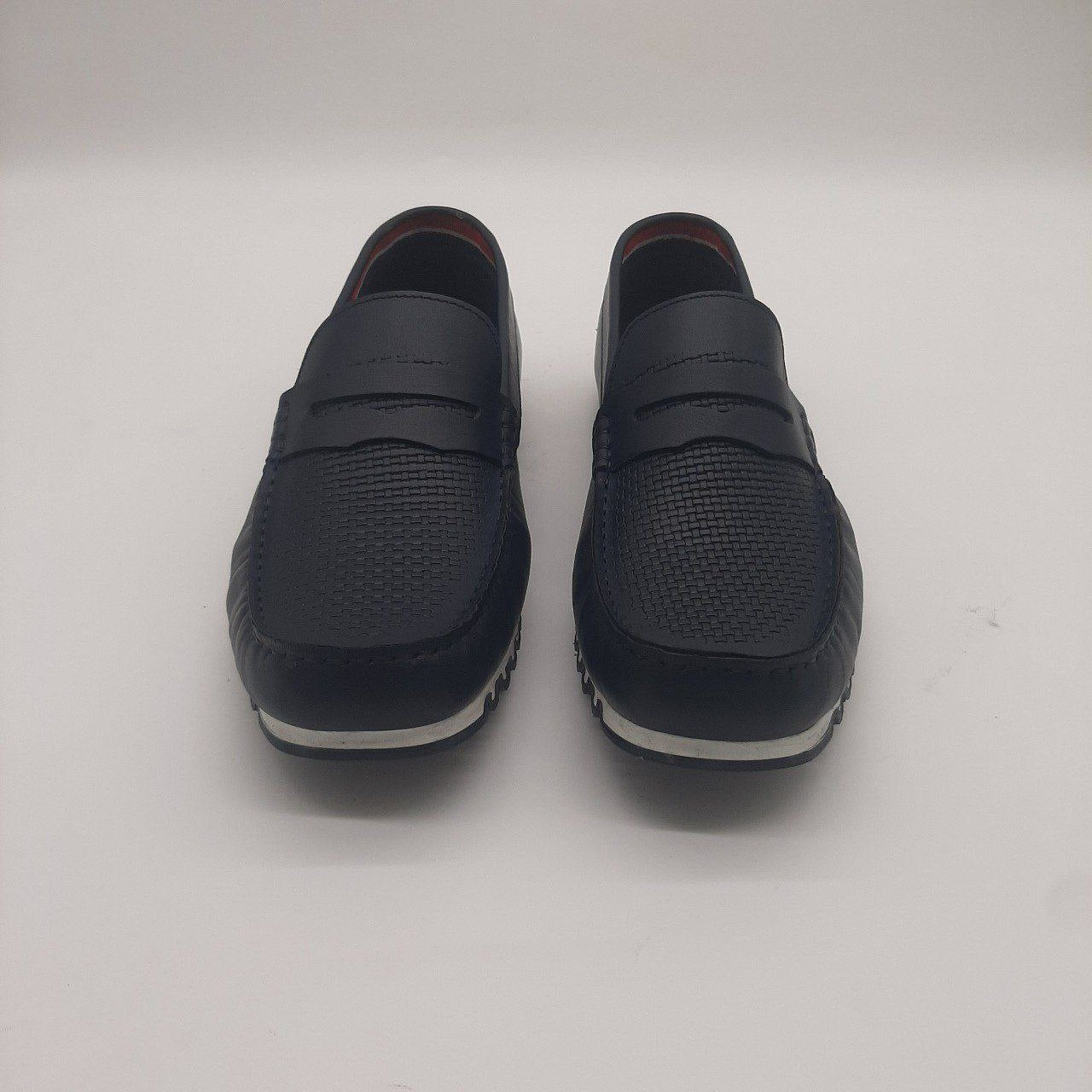 a pair of black shoes standing next to a pair of shoes 