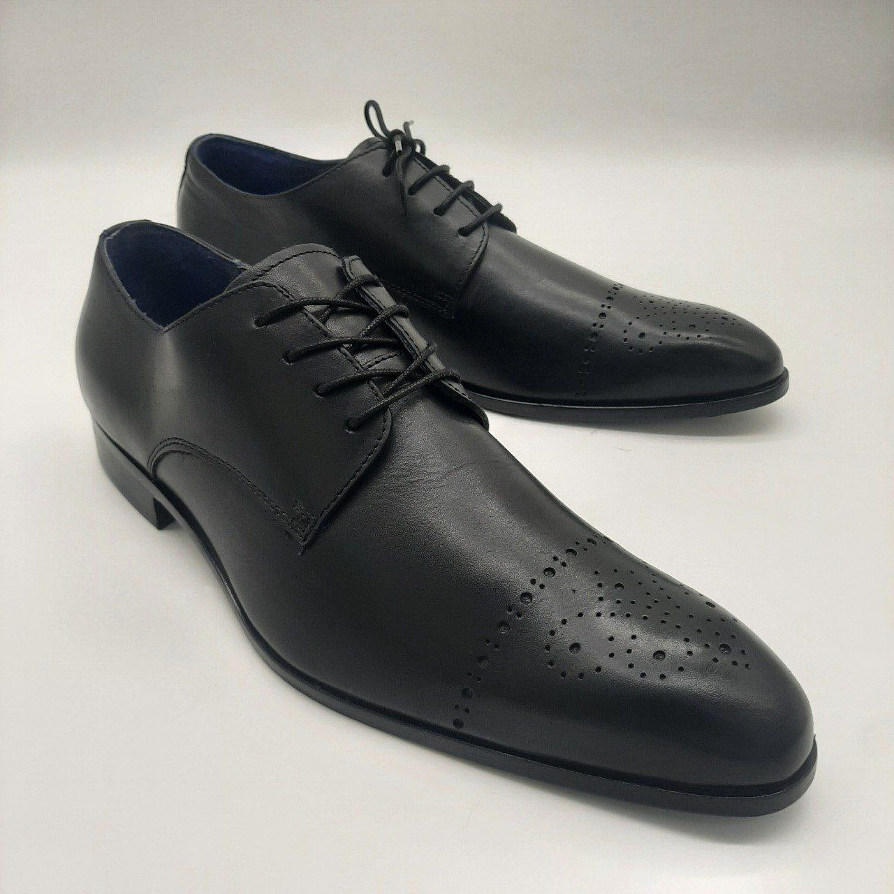 a close up of a pair of black shoes 