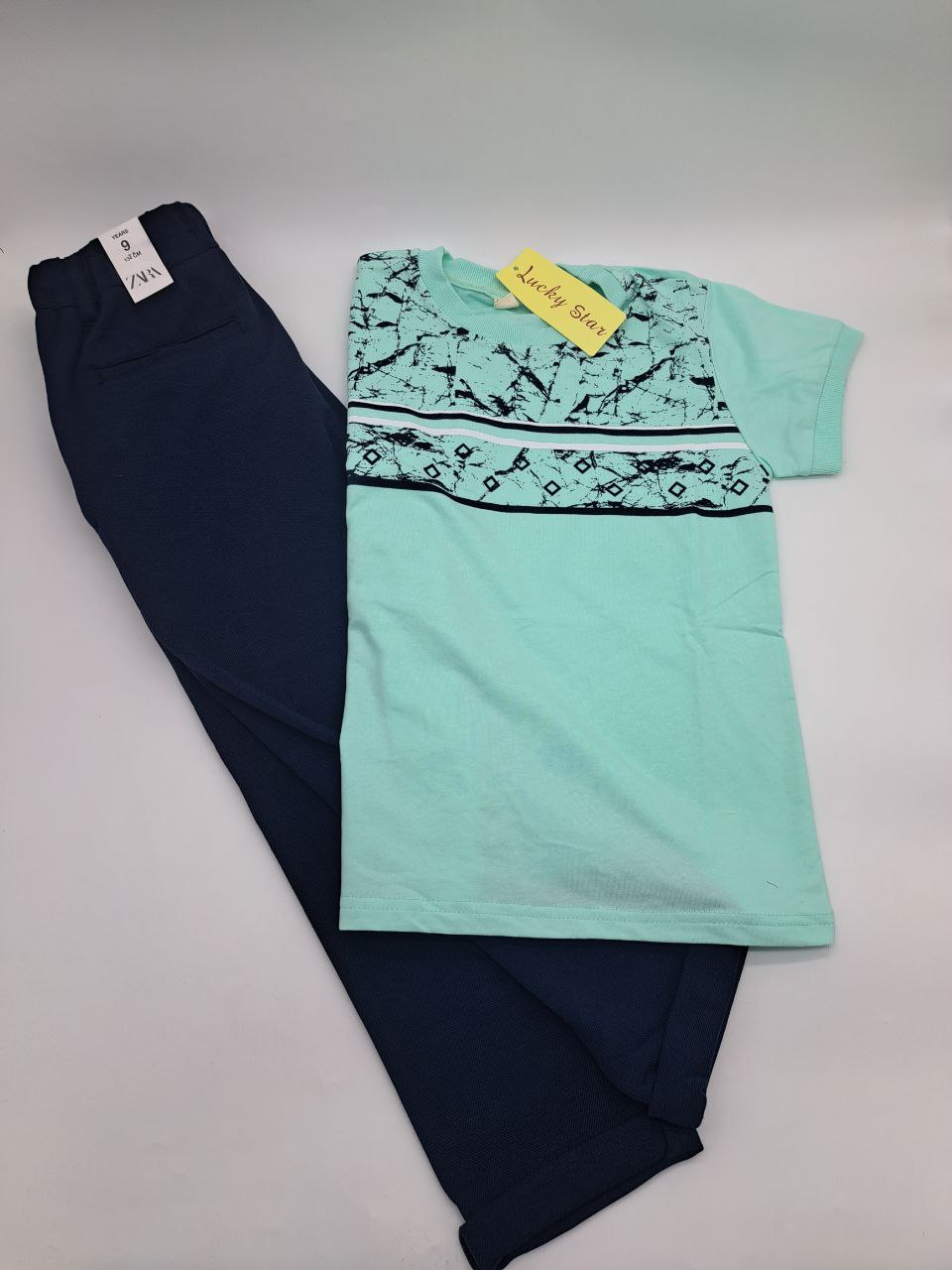 a black and white umbrella sitting on top of a wall 