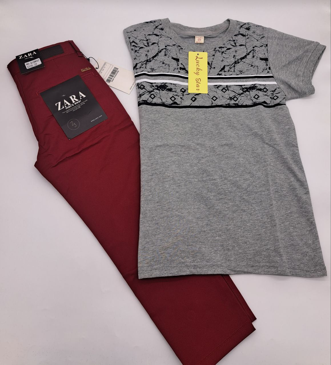 a red and black tie is on a white surface 