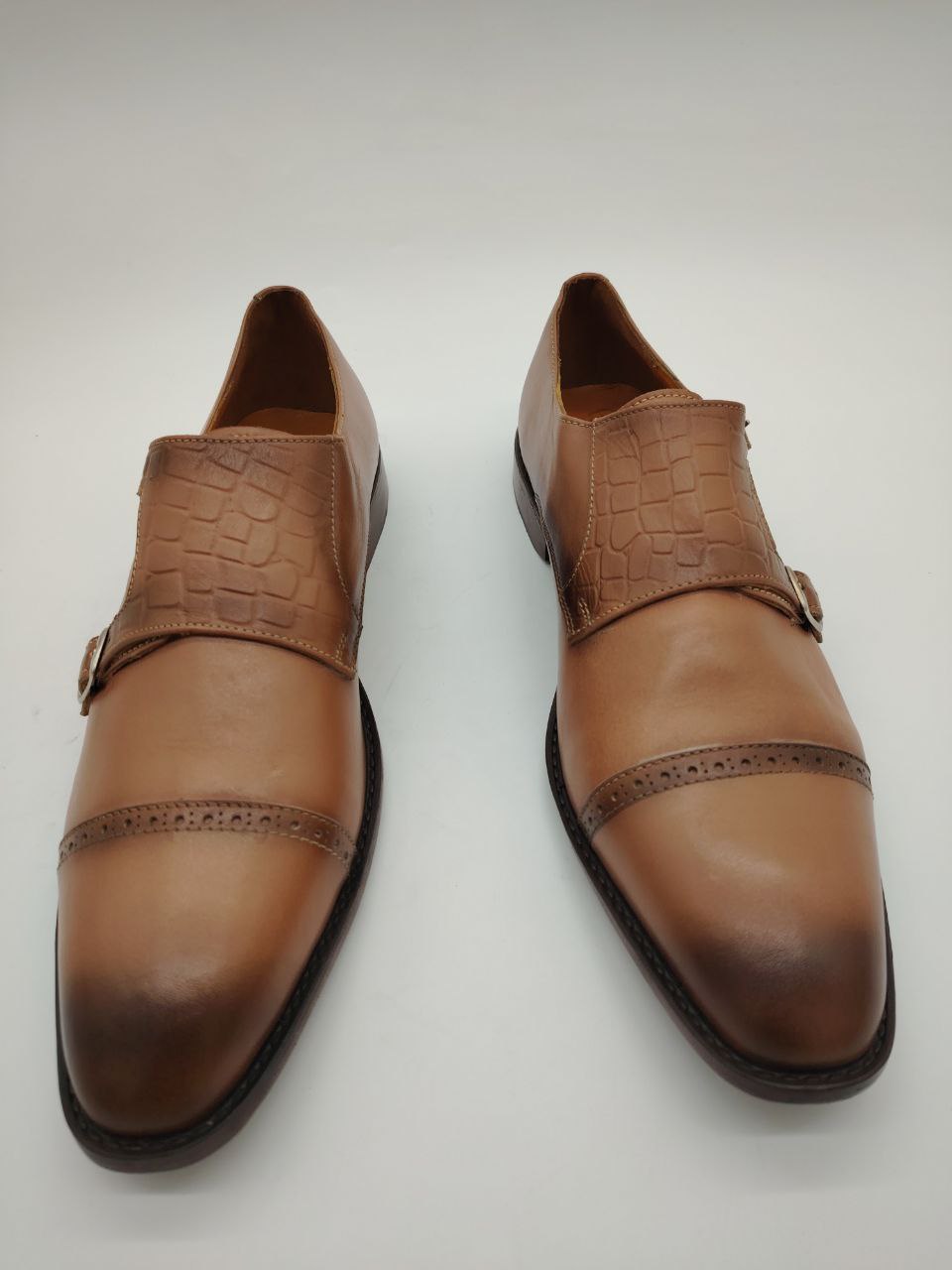 a pair of brown shoes and a pair of shoes 