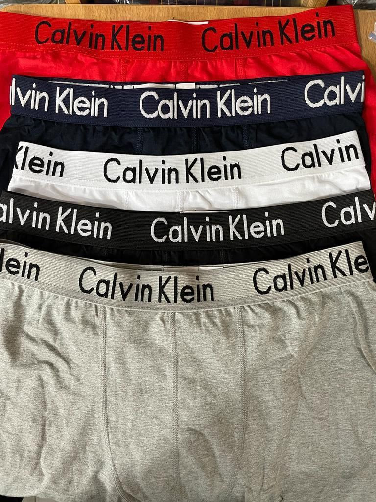 a sign that is sitting on a bed 